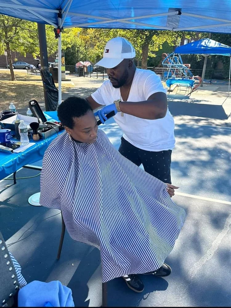 Community service barber at Winnin Against Addiction outdoor event supporting Boston recovery