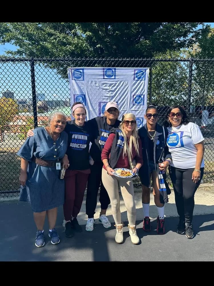Past years Winnin Against Addiction volunteers at basketball court event with food service in Boston