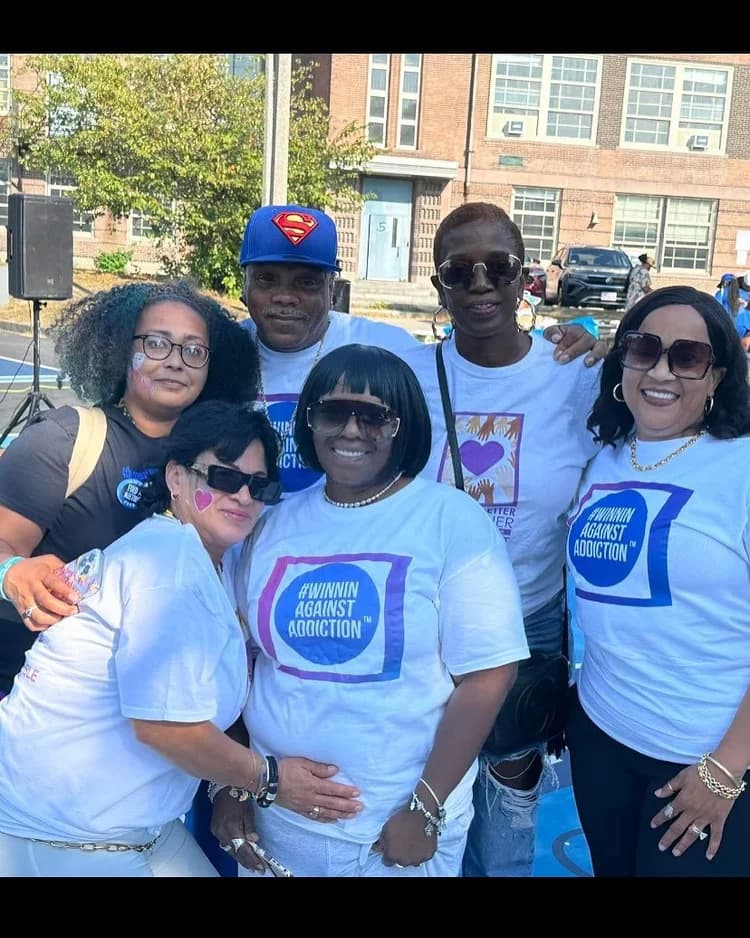 Winnin Against Addiction community group photo at outdoor awareness event in Boston
