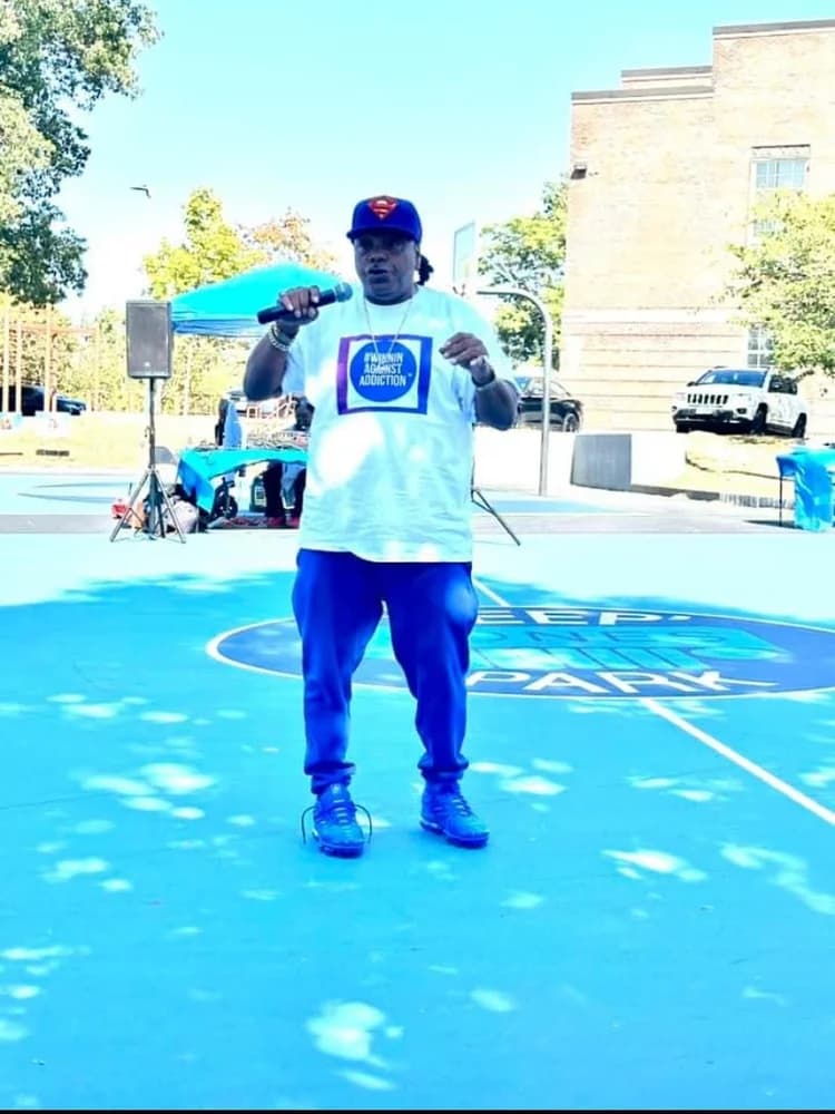 Speaker at Winnin Against Addiction basketball court event supporting Boston recovery