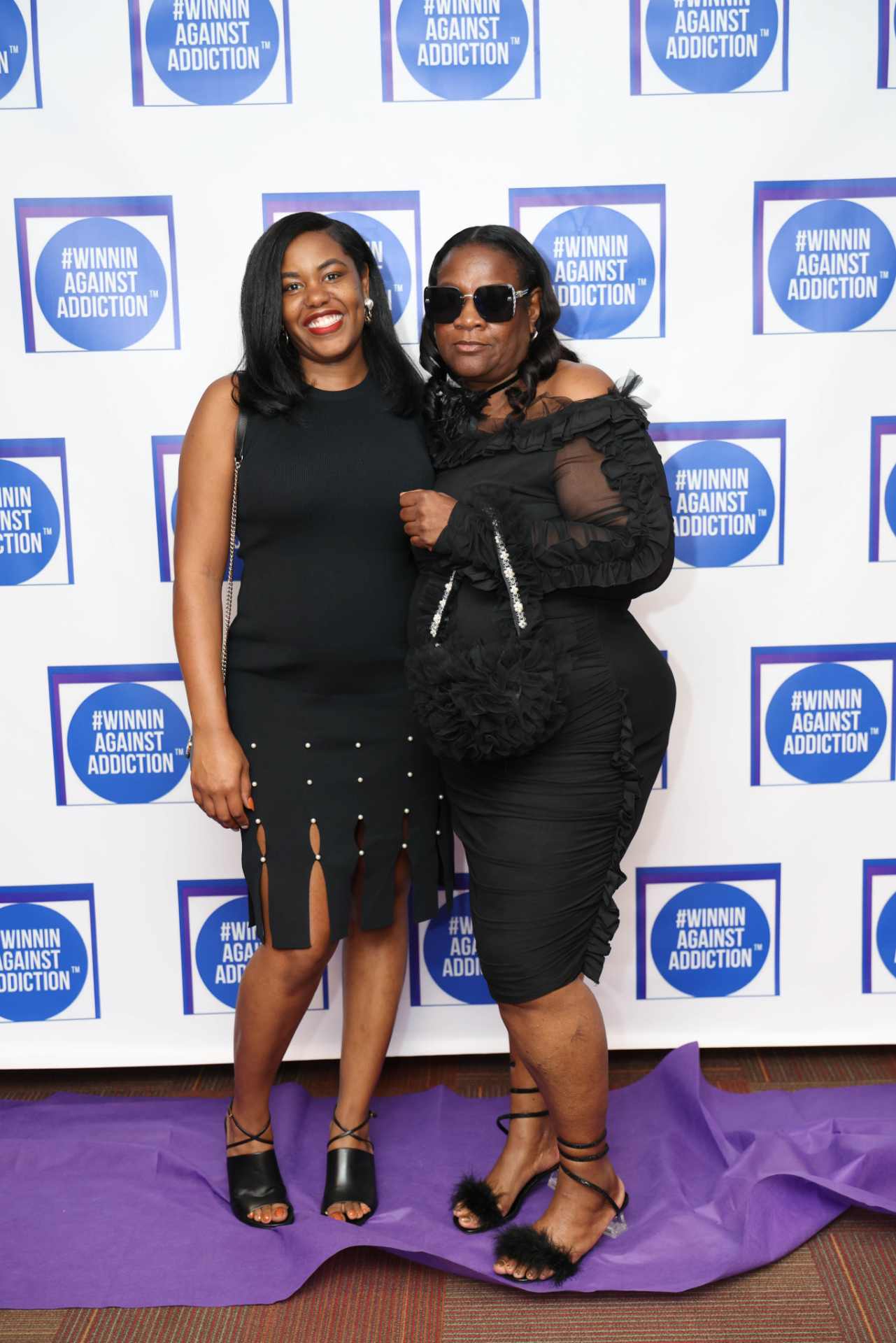 2025 community members on purple carpet at Winnin Against Addiction annual gala