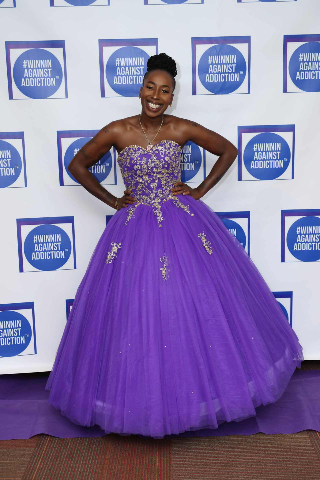 2025 annual gala attendee in purple ball gown at Winnin Against Addiction celebration