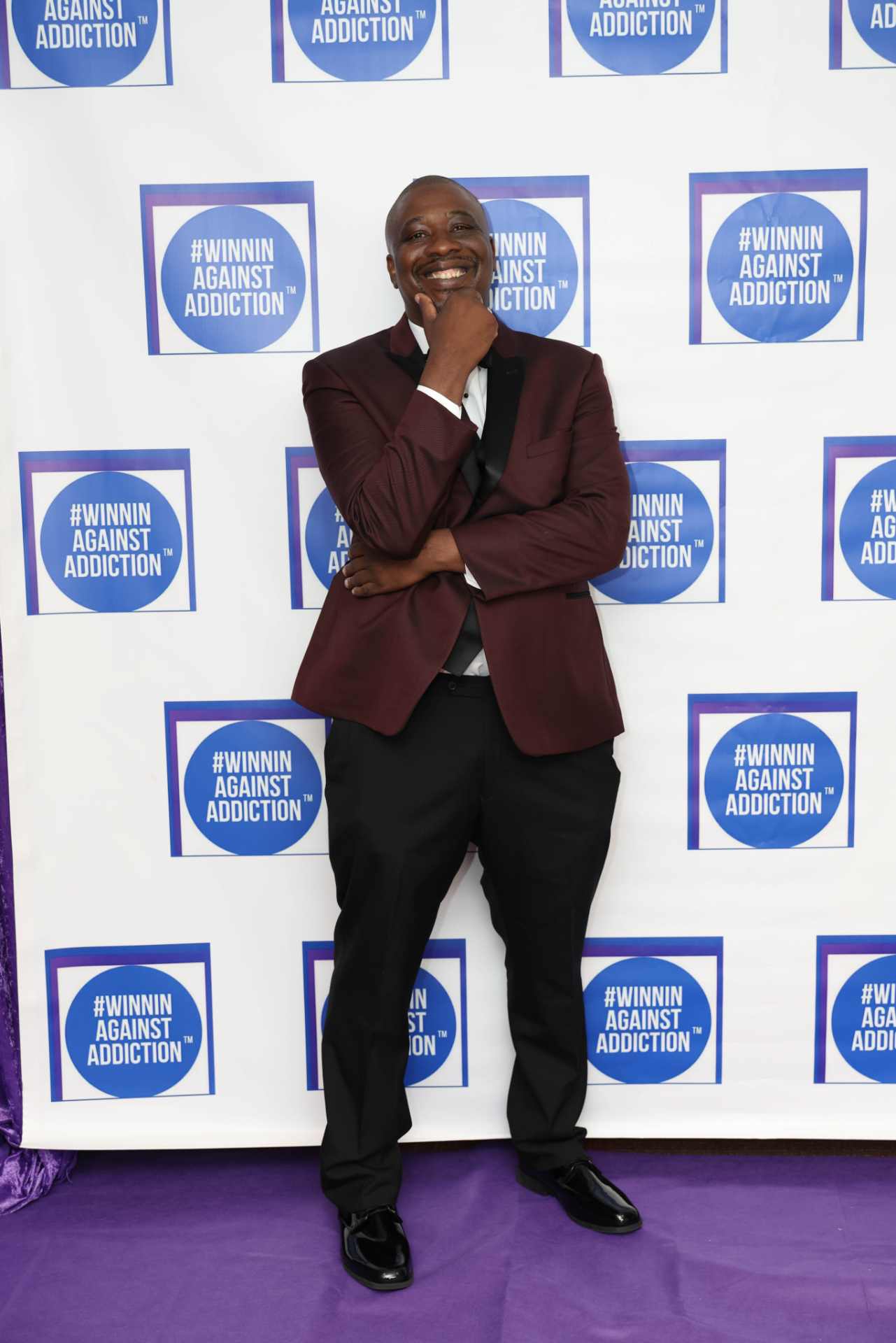 2025 Winnin Against Addiction gala honoree in burgundy blazer celebrating recovery in Boston