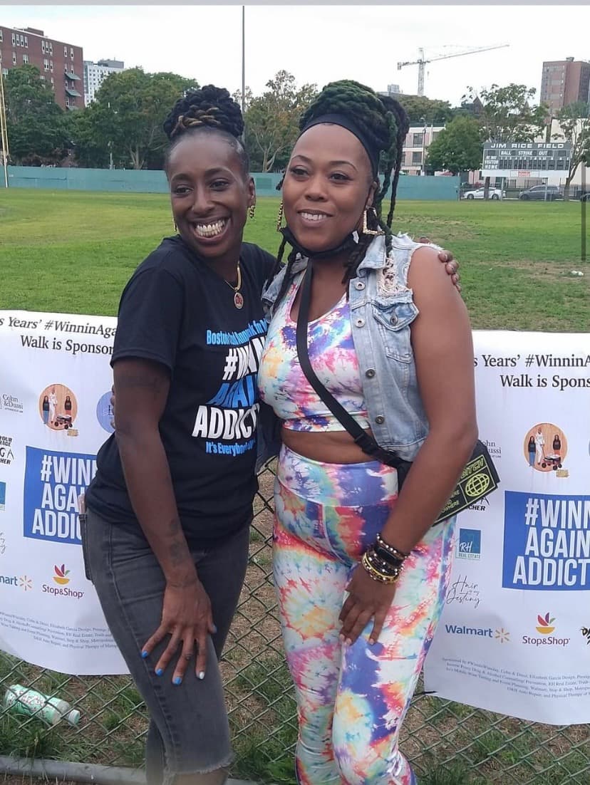 2023 supporters celebrating at Winnin Against Addiction outdoor walk with sponsor banners in Boston