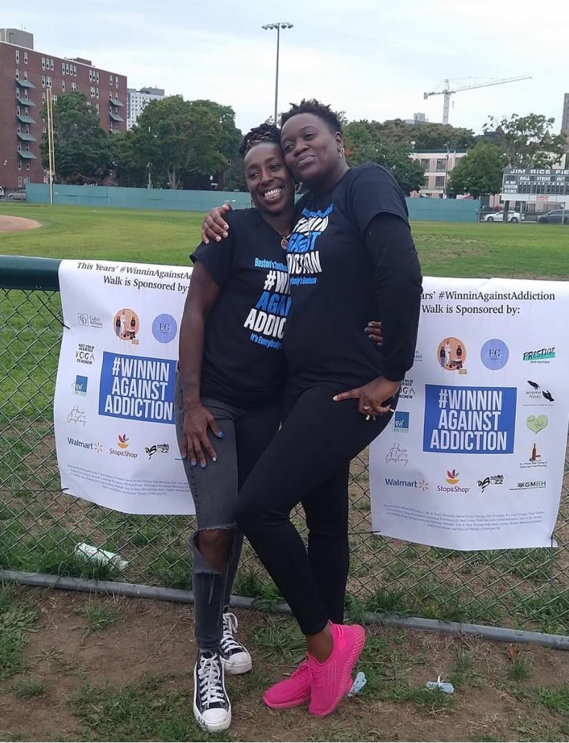 2023 Boston Walk for Addiction participants at Winnin Against Addiction event with branded banner and blue balloons