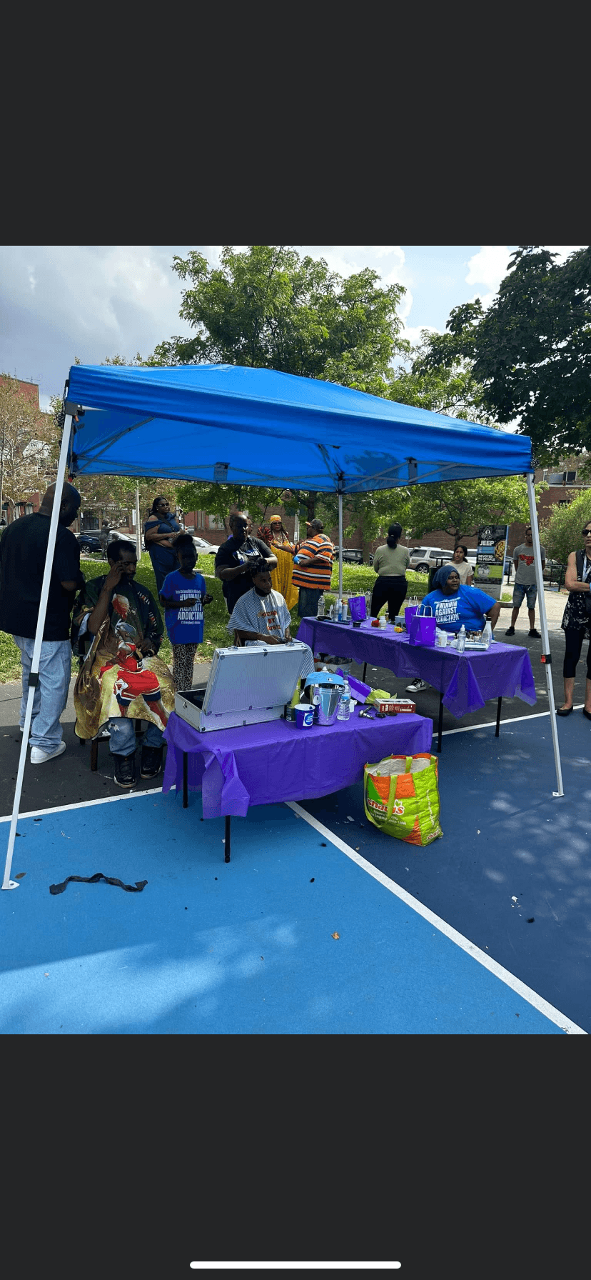 2022 Winnin Against Addiction community outreach tent with resource tables at Boston outdoor event