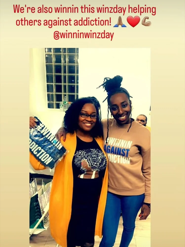 Community advocates with Winnin Against Addiction materials at Boston indoor event