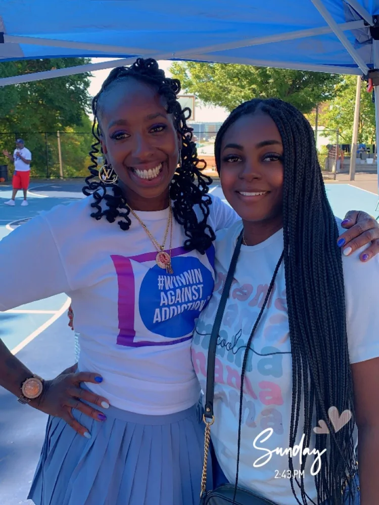 Community members at Winnin Against Addiction tent event in Boston