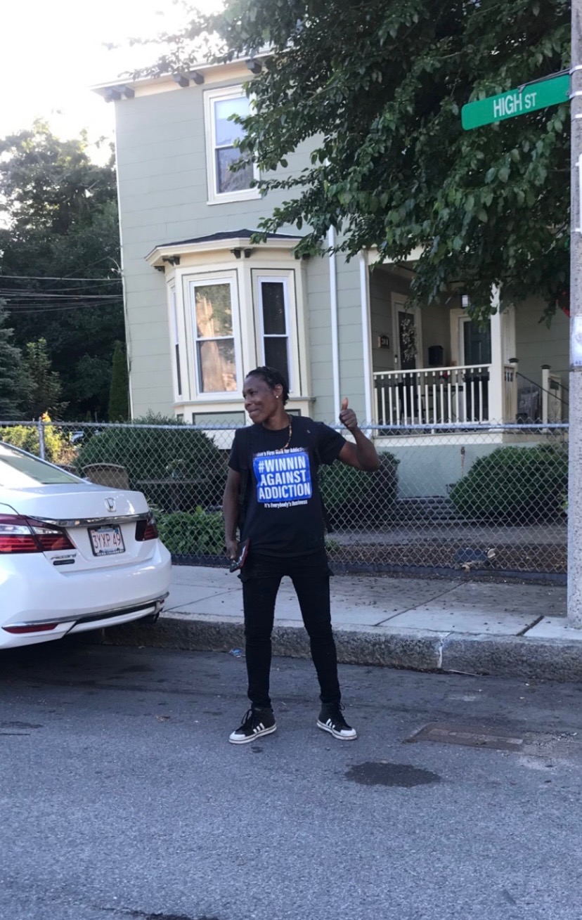 2023 Winnin Against Addiction community advocate wearing branded shirt at Boston neighborhood awareness event